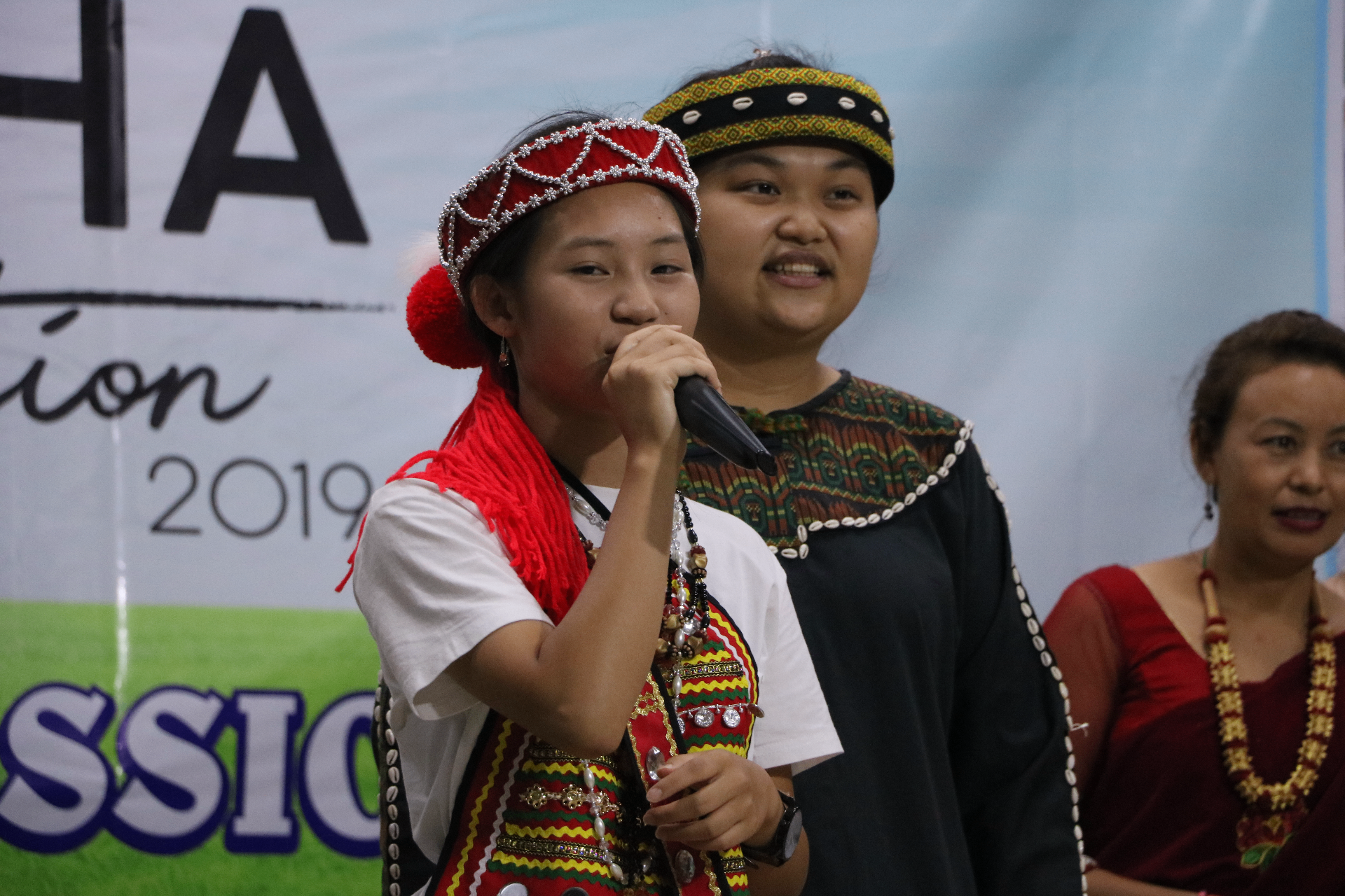 Young woman leading worship in traditional dress